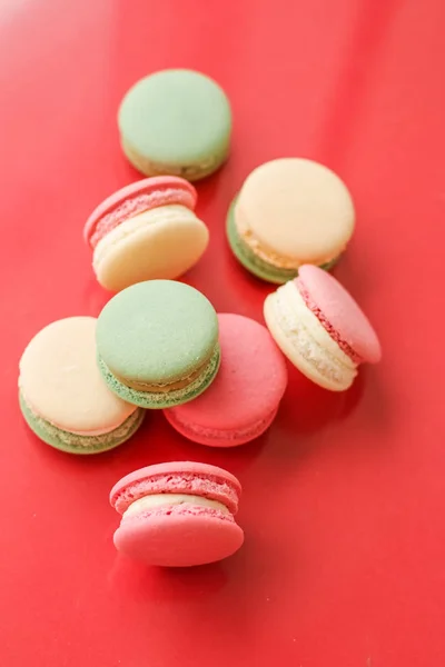 French macaroons on red background, parisian chic cafe dessert,