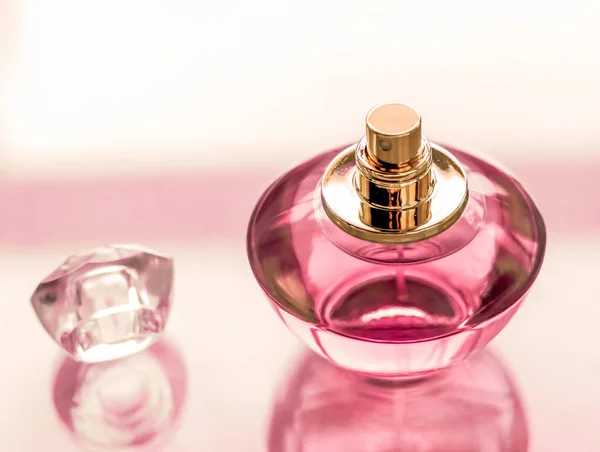 Rosa Parfümflasche auf glänzendem Hintergrund, süßer blumiger Duft, — Stockfoto