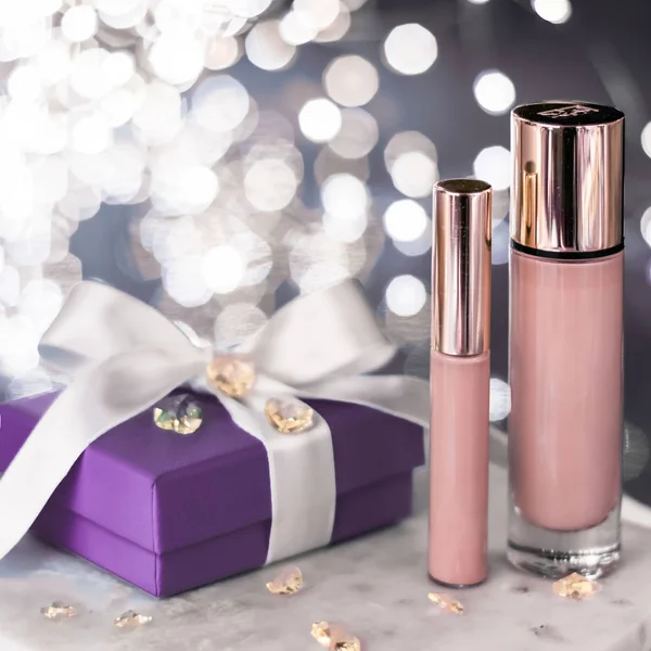 Holiday make-up foundation base, concealer and purple gift box,