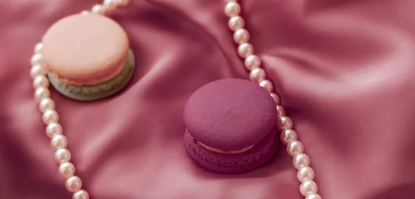 Süße Makronen und Perlen Schmuck auf Seidengrund, Parisia — Stockfoto