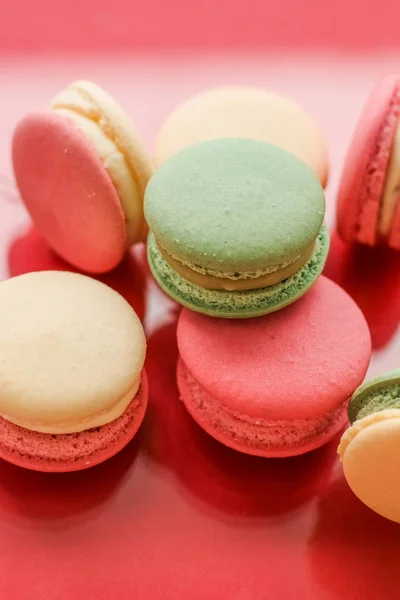 French macaroons on red background, parisian chic cafe dessert,