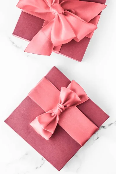 Coral gift box with silk bow on marble background, girl baby sho — Stock Photo, Image