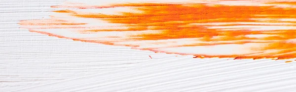 Artistic abstract texture background, orange acrylic paint brush