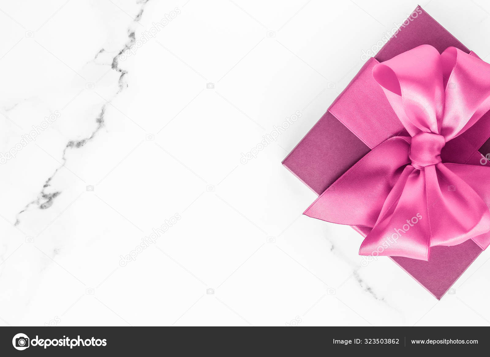 Black silk ribbon and bow on marble background, flatlay, Stock image
