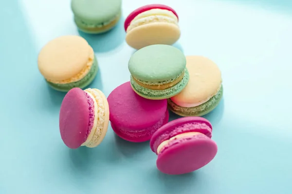 French macaroons on blue background, parisian chic cafe dessert,