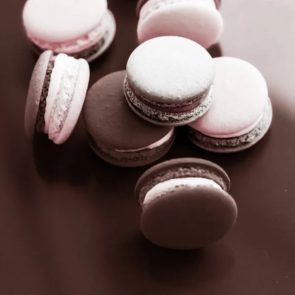 French macaroons on milk chocolate background, parisian chic caf