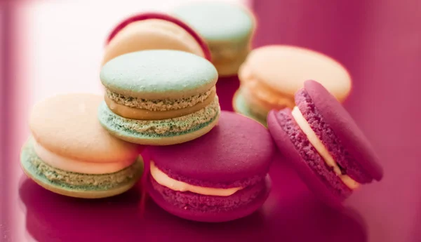 French macaroons on cherry pink background, parisian chic cafe d
