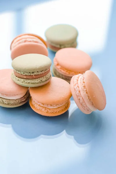 French macaroons on blue background, parisian chic cafe dessert, — ストック写真