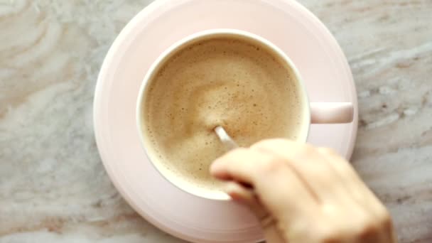 아침에 커피 컵에 구슬로 만든 평평 한 바닥에 우유를 놓고 놓고 놓고, 탁자 위에 뜨거운 음료를 놓고, 맨 위에서 음식 비디오를 보고 — 비디오
