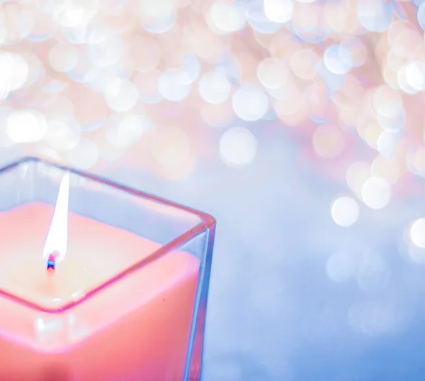 Coral aromatic candle on Christmas and New Years glitter backgro — Stock Photo, Image