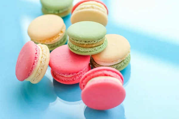 French macaroons on blue background, parisian chic cafe dessert,