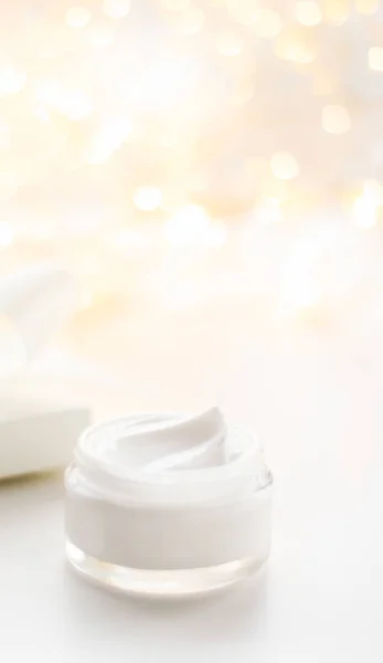 Facial cream moisturizer jar on holiday glitter background, mois