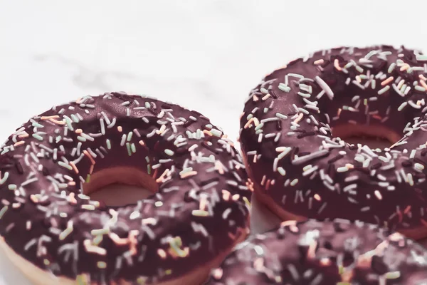 Milchig bestreute Donuts, süßes Gebäck Dessert auf Marmortisch — Stockfoto