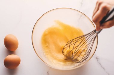 Ev yapımı yemek olarak mermer masada yumurta karıştırmak.