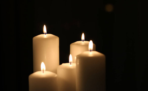 Aromatic vanilla yellow candles set at night, Christmas, New Yea