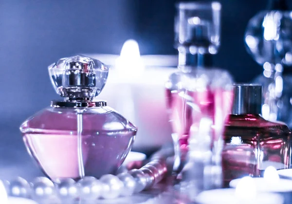 Perfume bottle and vintage fragrance on glamour vanity table at