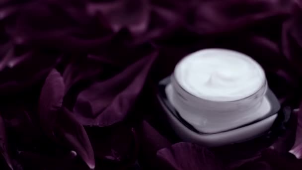 Sensitive skincare moisturizer face cream on flower petals and water background, natural science for skin — Stock Video