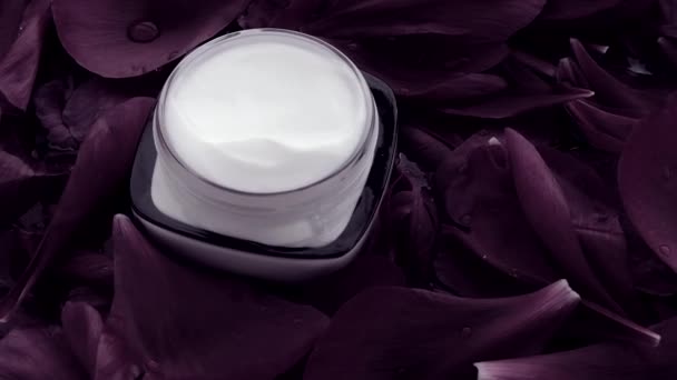 Sensitive skincare moisturizer face cream on flower petals and water background, natural science for skin — Stock Video