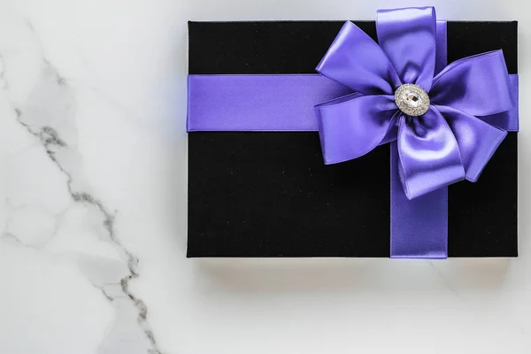 Luxury holiday gifts with lavender silk ribbon and bow on marble — Stock Photo, Image