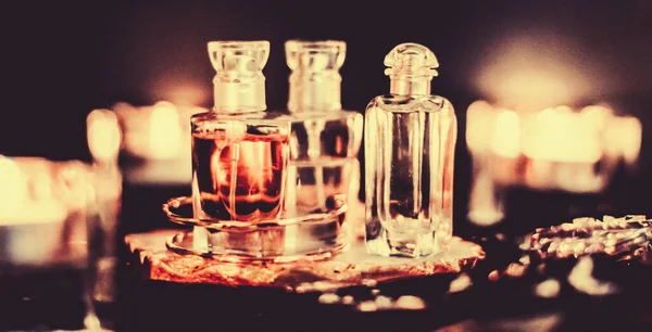 Perfume bottles and vintage fragrance at night, aroma scent, fra