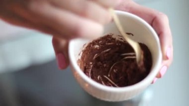 Making of chocolate body mask, mixing ingredients for diy cosmetics recipe at home, spa skincare product made of cocoa, honey and milk. Natural beauty routine