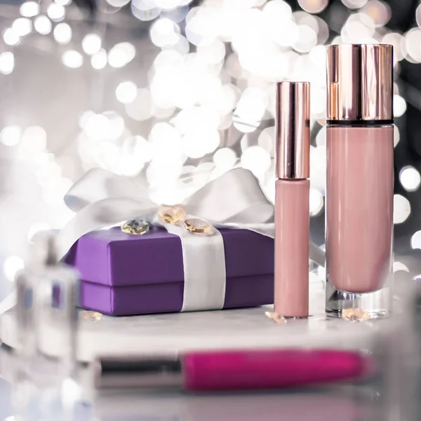 Holiday make-up foundation base, concealer and purple gift box,