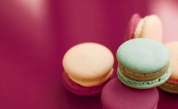 French macaroons on cherry pink background, parisian chic cafe d