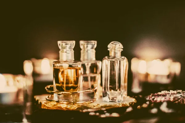 Perfume bottles and vintage fragrance at night, aroma scent, fra