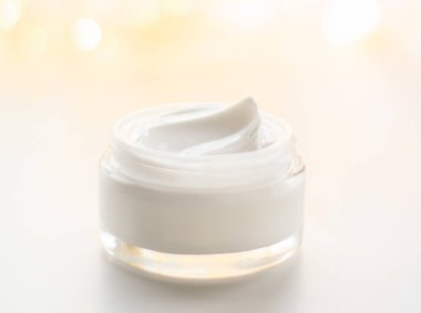 Facial cream moisturizer jar on holiday glitter background, mois clipart