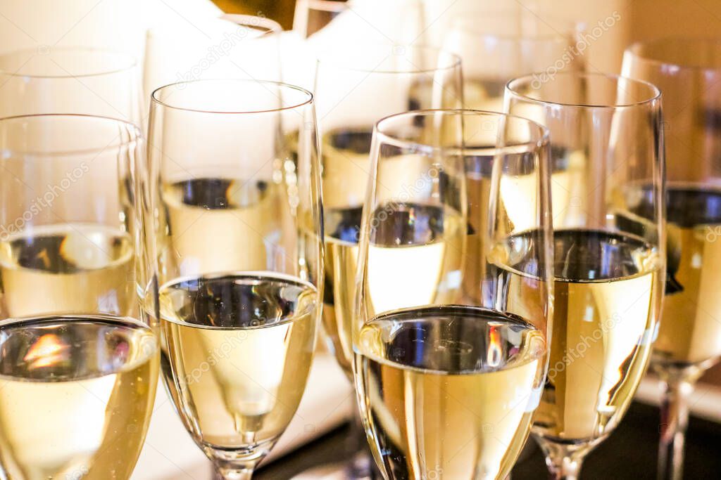 Drinks, celebration and luxury concept - Glasses of champagne and sparkling wine served on a tray at charity event