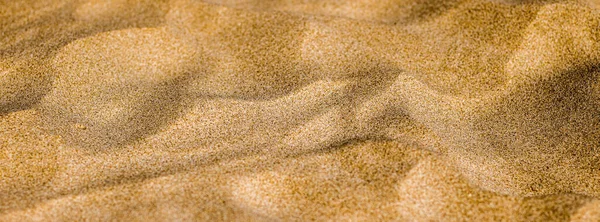 Arena en la playa en verano, textura como fondo —  Fotos de Stock