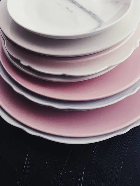 Stack of clean empty plates on black background, dishware and table decor — Stock Photo, Image
