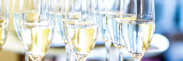 Glasses of champagne and sparkling wine served at charity event, alcoholic drinks