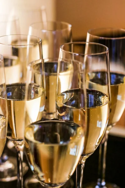 Glasses of champagne and sparkling wine served at charity event, alcoholic drinks