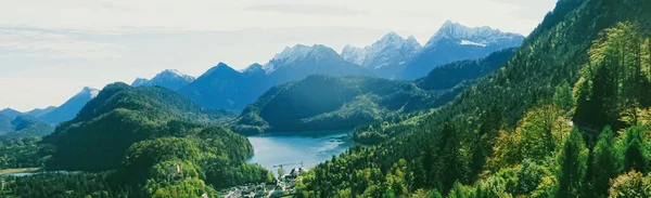 Beautiful nature of European Alps, landscape view of alpine mountains, lake and village in spring season, travel and destination