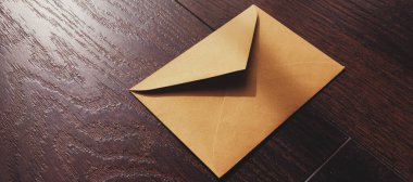 Ahşap arka planda, bültende ve mesajda altın antika zarf