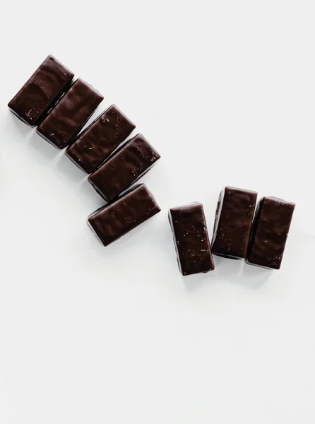 Tmavé čokoládové bonbóny izolované na bílém pozadí, sladké jídlo a dezert — Stock fotografie