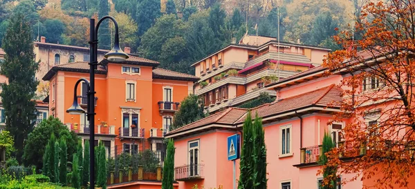 Residential buildings and gardens on the streets of Milan in Northern Italy, classic and historical European architecture in Lombardy region