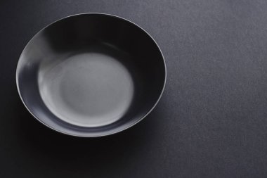 Siyah arka planda boş tabaklar, bayram yemeği için kaliteli bulaşık takımı, minimal tasarım ve diyet