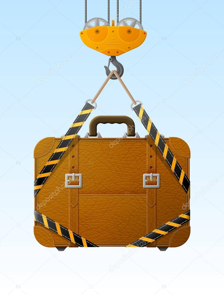 Suitcase hanging on crane hook