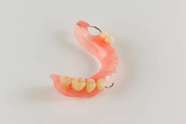 Acrylic denture with metal clasps — Stock Photo, Image