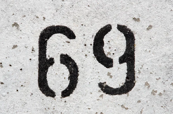 Number 69 painted on a white wall — Stock Photo, Image