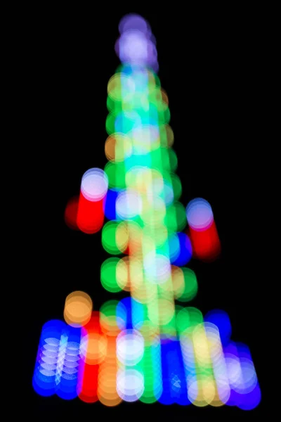 Bokeh de Natal de cor em um fundo escuro . — Fotografia de Stock