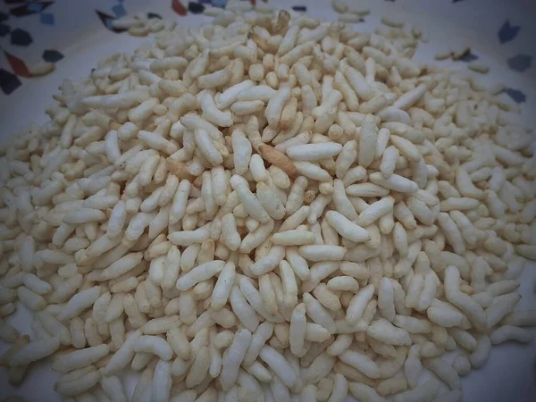 Puffed rice on the plate. It refers to various foods made by introducing air into rice. Muri, also known as mudhi or murai, laiyya or murmureis a type of puffed grain from the Indian subcontinent