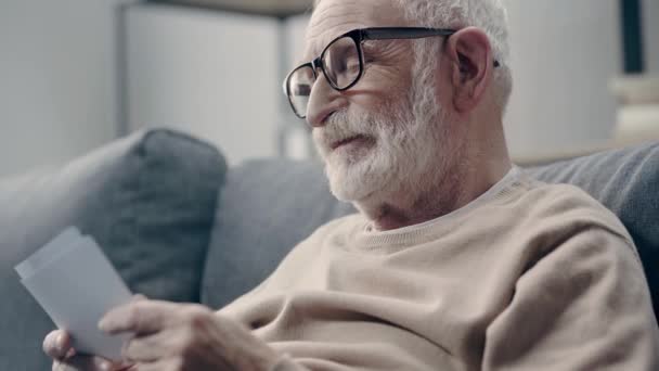Demenzkranker Senior Schaut Sich Fotos — Stockvideo
