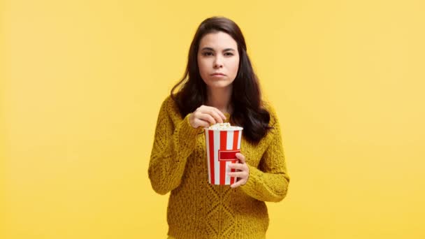 Concentrated Girl Sweater Eating Popcorn Isolated Yellow — Stock Video