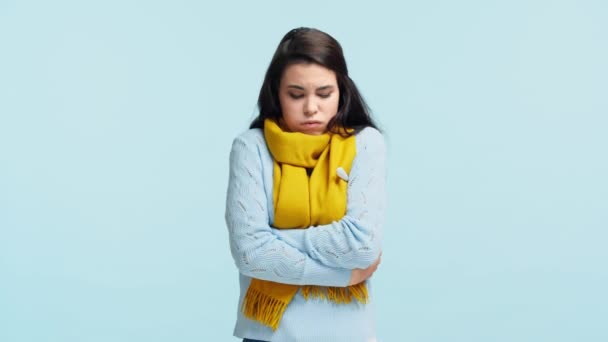 悲しい病気の女の子ですスカーフで温度を測定ブルーに隔離されました — ストック動画