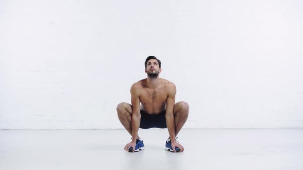 Sportsman Squatting Sit Position White Background — Stock Video