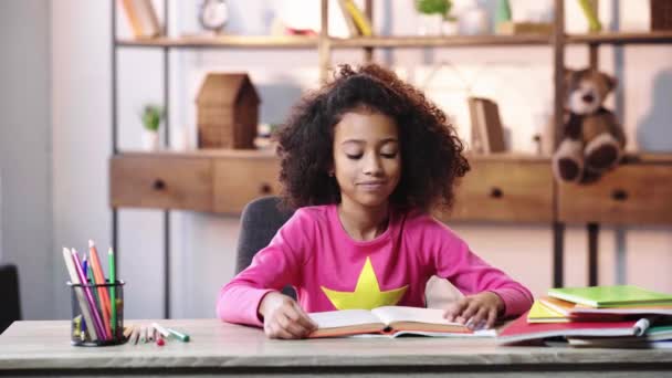 Smiling African American Child Reading Book Showing Thumb — Stock Video