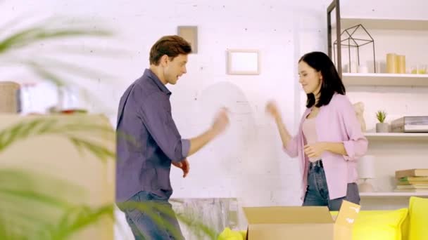 Young Couple Playing Rock Paper Scissors Packages New Home — Stok video